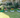 A well-designed garden with raised planting beds filled with vibrant flowers and greenery.