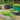 Galvanized oval raised garden bed with vibrant green lettuce, showcasing durability and modern design.