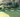 A well-designed garden with raised planting beds filled with vibrant flowers and greenery.
