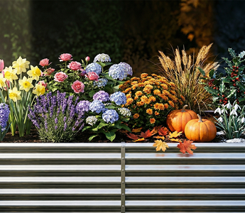 A vibrant and diverse garden display featuring an assortment of colorful flowers, plants, and seasonal decor in raised planting beds.
