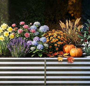 A vibrant and diverse garden display featuring an assortment of colorful flowers, plants, and seasonal decor in raised planting beds.