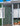 Chickens moving around and interacting with a mobile coop enclosed by hardware cloth.- Land Guard
