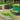 Galvanized oval raised garden bed with corrugated metal, planted with vegetables, available in silver, black, and green.