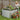 36" tall galvanized raised garden bed filled with colorful flowers, being watered by a woman.
