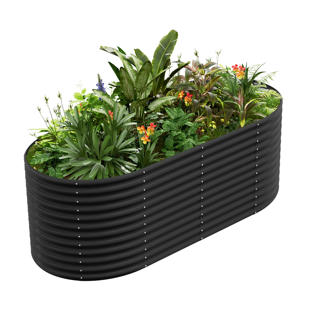 Black corrugated metal raised garden bed, oval shaped, filled with diverse plants and flowers.